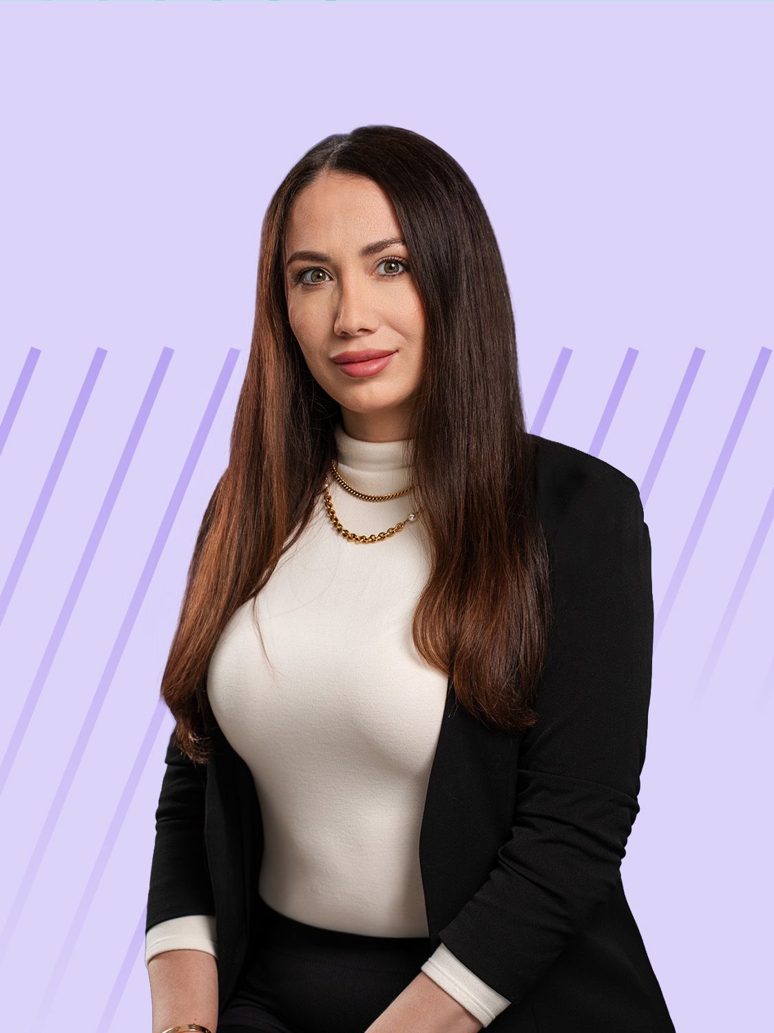Professional woman with long dark hair, white turtleneck, and black blazer posing confidently.
