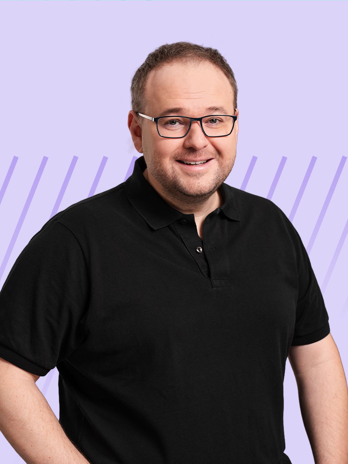 A smiling man wearing glasses and a black polo shirt against a purple background.